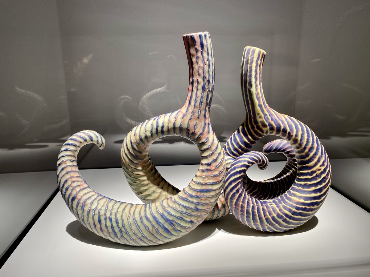 Striped ceramic sculptures in a museum